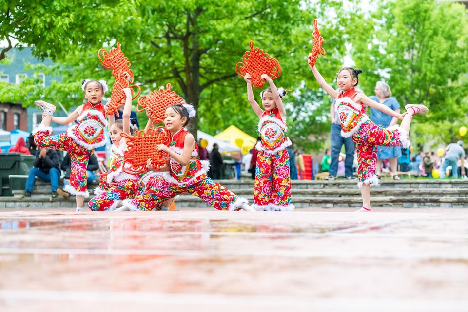 Young Chinese girls performing outside in traditional clothing