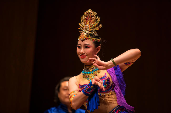 woman dressed in traditional Wayang dance clothing performing on stage