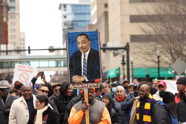 People gathered holding a picture of MLK at MLK march 