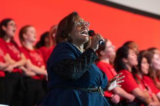Woman singing in the Uniting Voices Choir
